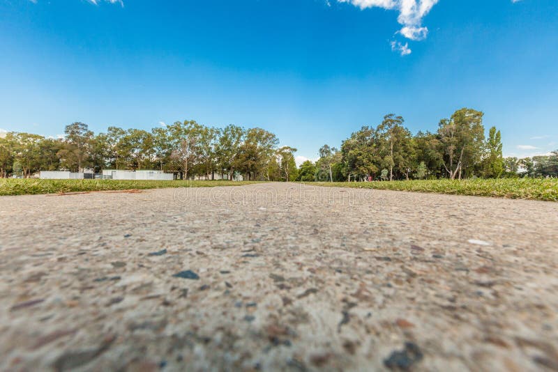 Low angle view of walkway leading into the distance with trees. royalty free stock photo