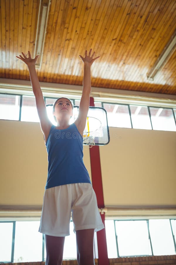Low angle view of woman playing basketball royalty free stock image