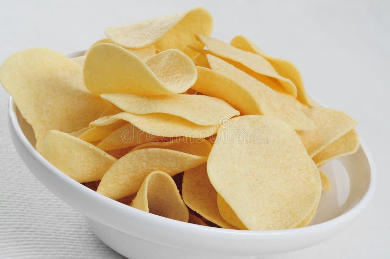 Closeup of a bowl with low fat potato chips on a table. Crispy diet stock images, royalty-free photos and pictures