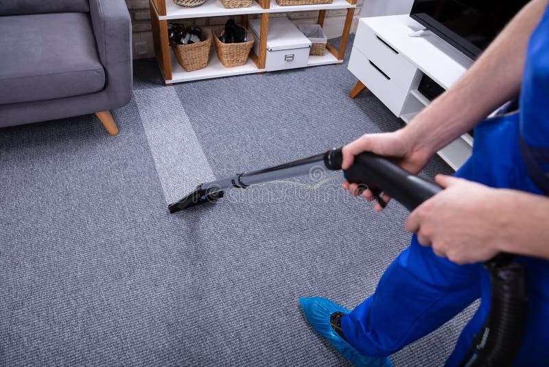 Male Janitor Cleaning Carpet