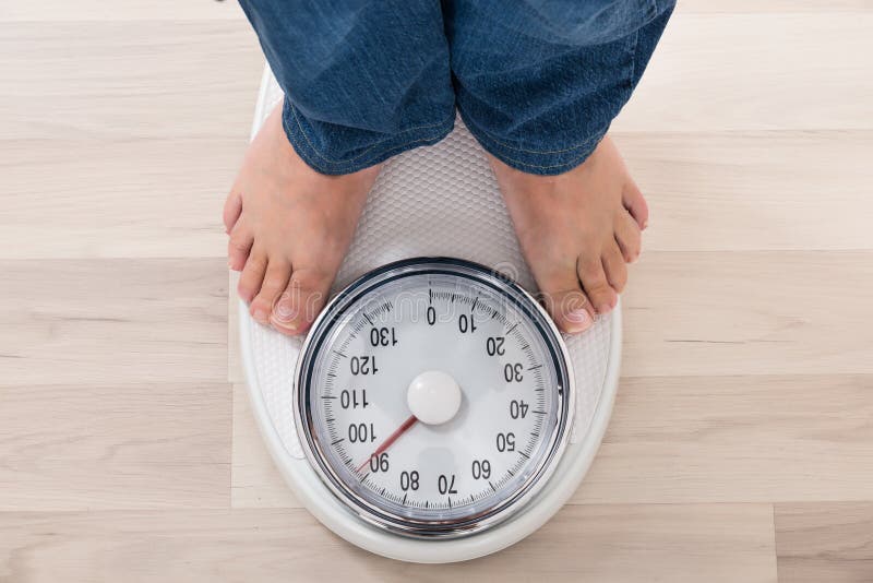 Bare feet standing on a scales. Lose weight concept with person on a scale  measuring kilograms. Weight Scale, Underweight man on Scale Stock Photo -  Alamy