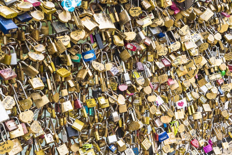 Paris, France 07.16.2016: Wall of love padlocks in a parisian bridge. Paris, France 07.16.2016: Wall of love padlocks in a parisian bridge