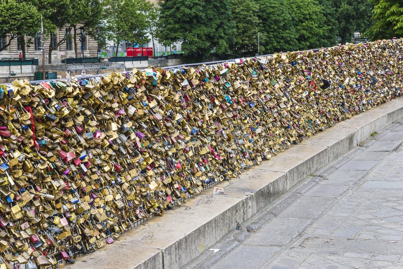 Paris, France 07.16.2016: Wall of love padlocks in a parisian bridge. Paris, France 07.16.2016: Wall of love padlocks in a parisian bridge