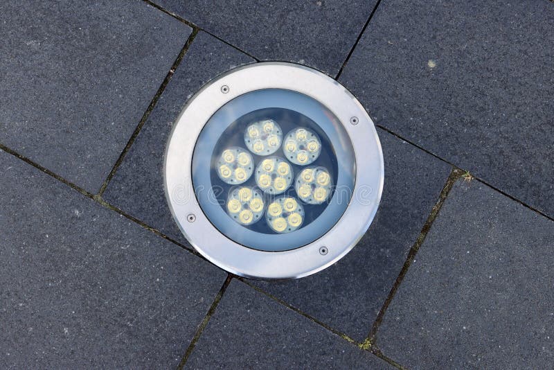 LED lamp with 7 lights installed in ground on a walkway. LED lamp with 7 lights installed in ground on a walkway