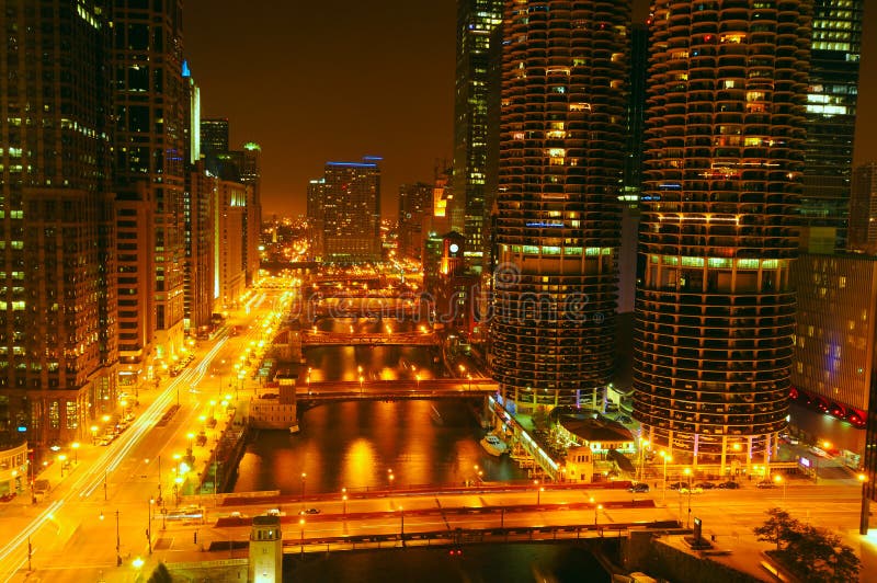 City lights glow over the Chicago River at night in Chicago Illinois. City lights glow over the Chicago River at night in Chicago Illinois