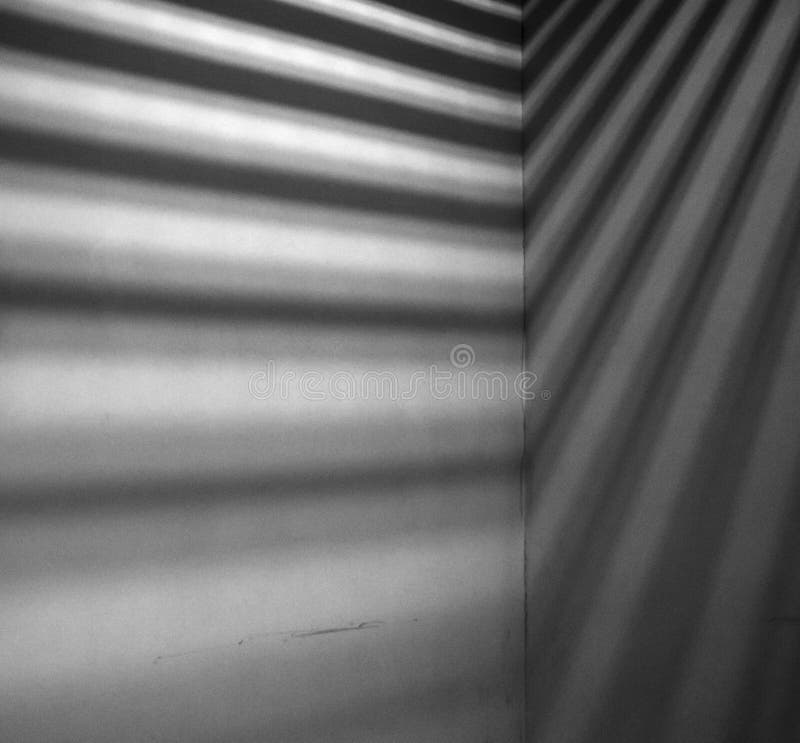 Minimalist image of lights and shadows falling on concrete wall. Image has grain texture - noise seen at 100 percent of its size. Minimalist image of lights and shadows falling on concrete wall. Image has grain texture - noise seen at 100 percent of its size.