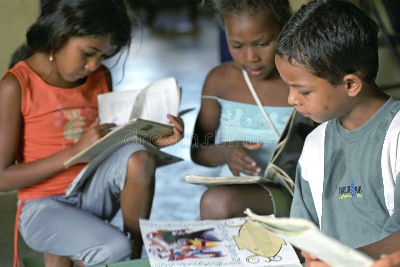 Brazil: In the Brazilian countryside is great illiteracy. In the vicinity of the village Conde has therefore the Organization Ivro and Roda launched a mobile library. Literacy project To increase the level of education among children reading books is a good start. This library car goes from school to school and the kids can pick out a storybook from the colorful bins. This boy and girls sitting attentively reading a book. These children read yet colorful children books with lots of pictures and drawings. State of Bahia in the North-East region. Brazil: In the Brazilian countryside is great illiteracy. In the vicinity of the village Conde has therefore the Organization Ivro and Roda launched a mobile library. Literacy project To increase the level of education among children reading books is a good start. This library car goes from school to school and the kids can pick out a storybook from the colorful bins. This boy and girls sitting attentively reading a book. These children read yet colorful children books with lots of pictures and drawings. State of Bahia in the North-East region.