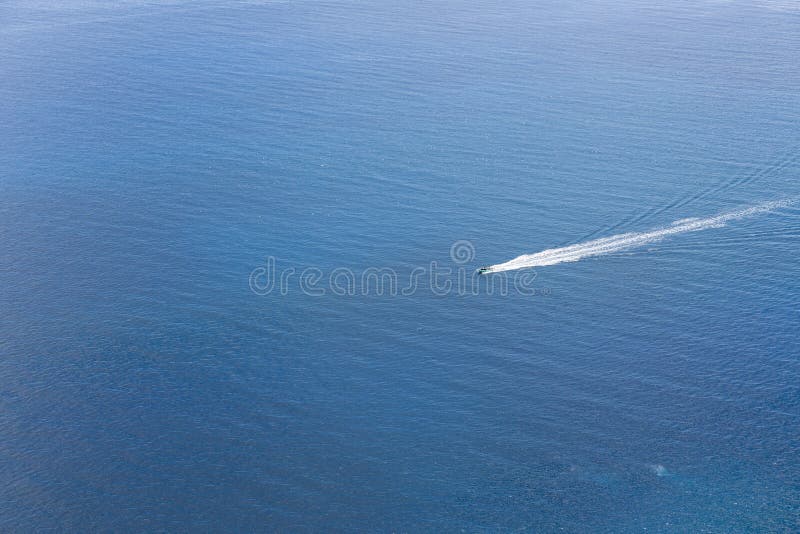 Luchtmening van een klein schip die bij een blauwe oceaan navigeren royalty-vrije stock fotografie Luchtmening van een klein schip die bij een blauwe oceaan navigeren royalty-vrije stock fotografie