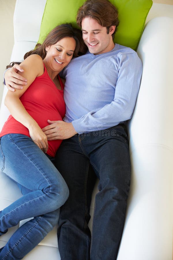 Luchtmening van Mens het Ontspannen op Sofa With Pregnant Wife royalty-vrije stock foto's Luchtmening van Mens het Ontspannen op Sofa With Pregnant Wife royalty-vrije stock foto's