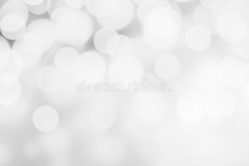 Luci astratte bianche e d'argento del bokeh Defo scintillante di Natale immagini stock Luci astratte bianche e d'argento del bokeh Defo scintillante di Natale immagini stock