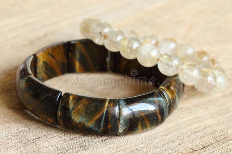 Lucky stone bracelets on wood background