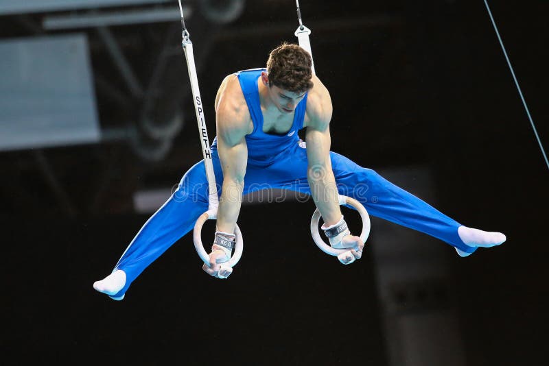 Szczecin, Poland, April 10, 2019:	 Ludovico Edalli of Italy competes on the rings during the artistic gymnastics championships. Szczecin, Poland, April 10, 2019:	 Ludovico Edalli of Italy competes on the rings during the artistic gymnastics championships