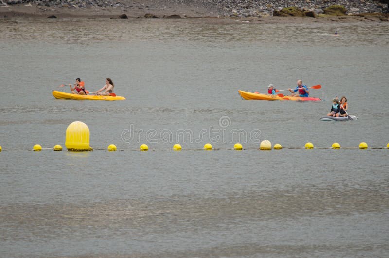 Los Cristianos, October 24, 2021: People kayaking in the coast of Tenerife. Canary Islands. Spain. Los Cristianos, October 24, 2021: People kayaking in the coast of Tenerife. Canary Islands. Spain.