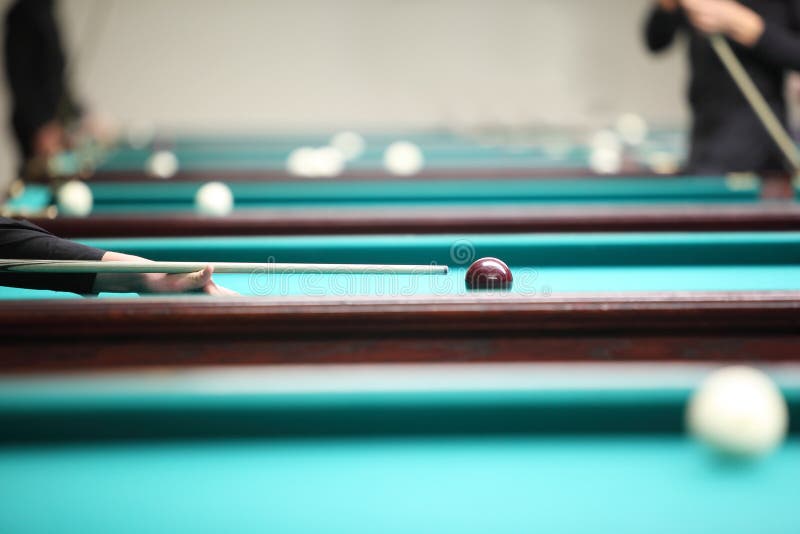 People play in pool in billiard club, focus on ball, hand. People play in pool in billiard club, focus on ball, hand