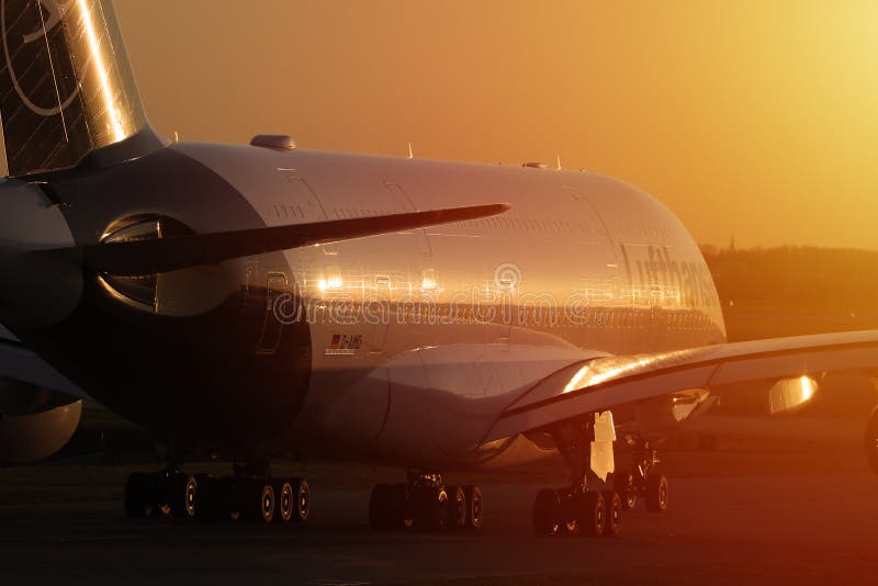 Lufthansa plane at sunset, orange light royalty free stock image