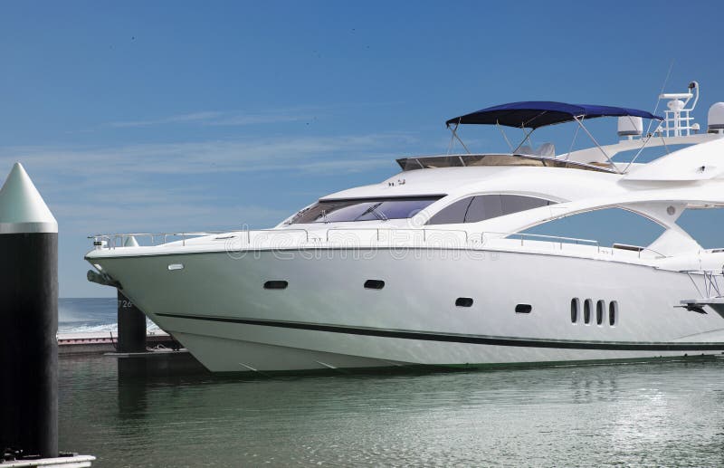 A Luxury Yacht parked in its berth in one of the famous upcoming luxury enclave in Dubai Marina. With clipping path. A Luxury Yacht parked in its berth in one of the famous upcoming luxury enclave in Dubai Marina. With clipping path