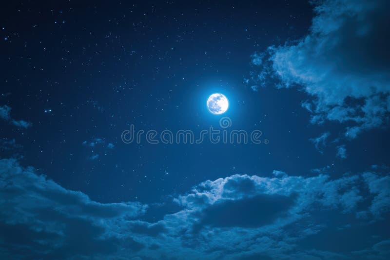 A luminous full moon surrounded by a clear starry night sky with soft, scattered clouds creating a serene and tranquil stock photo