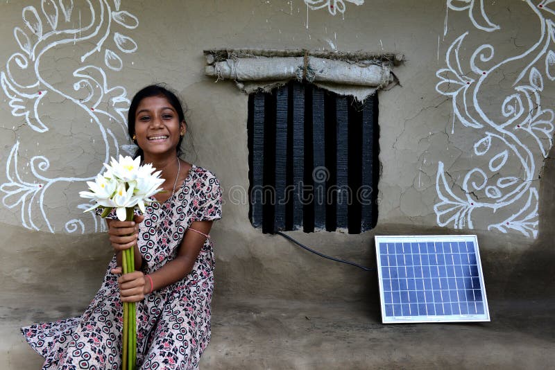Solar plate being charged in front of the painted house beside a adolescent girl smiling.Due to lack of electricity, more than 90 per cent of these islands remain in complete darkness after sunset. This year, the abundant sunshine in this region has been harnessed, to deliver these areas and the people from the darkness they have and suffered with. The state government had appointed the WBREDA as the nodal agency for its solar power project for the Sundarbans. Solar plate being charged in front of the painted house beside a adolescent girl smiling.Due to lack of electricity, more than 90 per cent of these islands remain in complete darkness after sunset. This year, the abundant sunshine in this region has been harnessed, to deliver these areas and the people from the darkness they have and suffered with. The state government had appointed the WBREDA as the nodal agency for its solar power project for the Sundarbans.