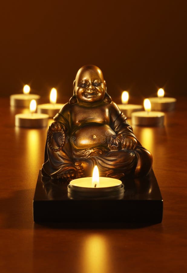 Laughing Buddha tea light holder with tea lights in background. Laughing Buddha tea light holder with tea lights in background