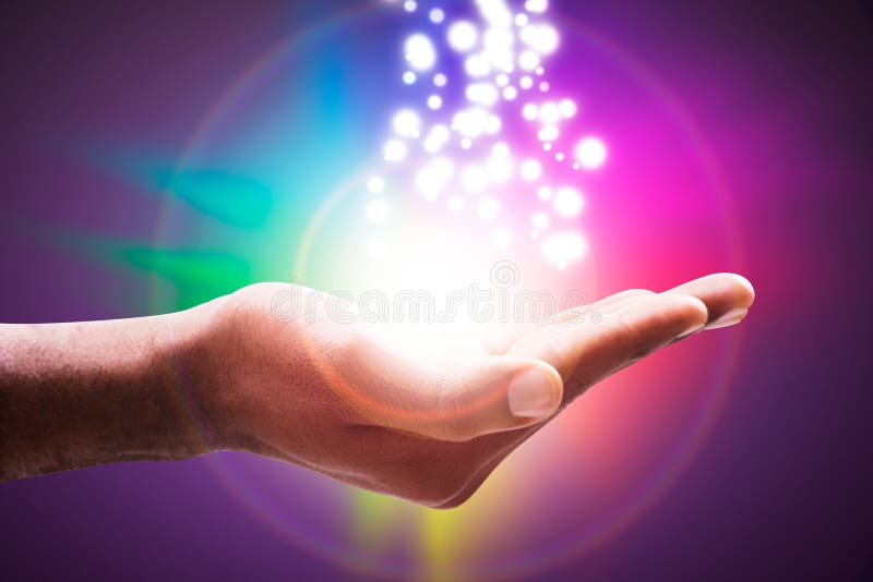 Glowing Lights Flowing From An Open Hand Against Colorful Circle Backdrop. Glowing Lights Flowing From An Open Hand Against Colorful Circle Backdrop
