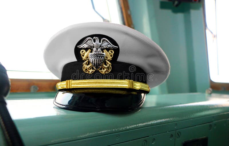 United State Navy USN officer`s hat on naval ship`s command bridge at Malaysian