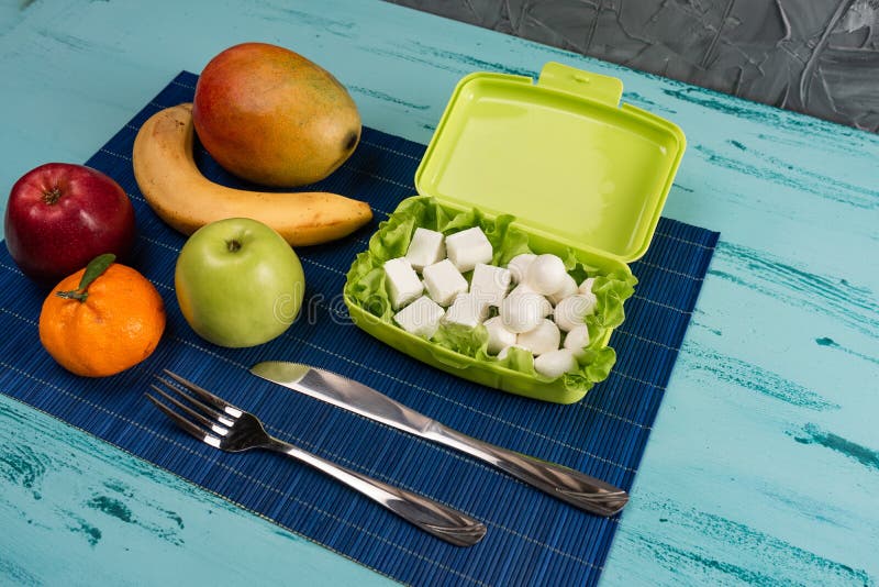 Lunch box with appetizing food and on light wooden table. Copy space. stock images Lunch box with appetizing food and on light wooden table. Copy space. stock images