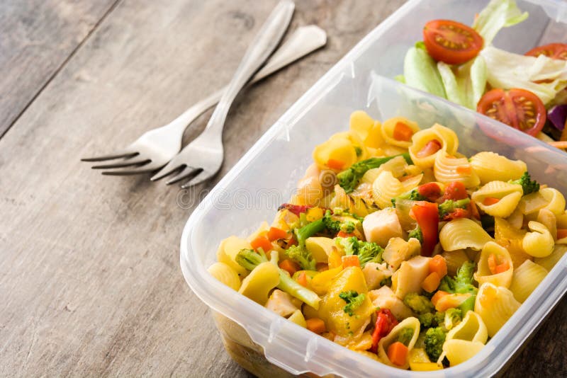 Lunch Box with Healthy Food Ready To Eat. Pasta Salad on Wooden Table