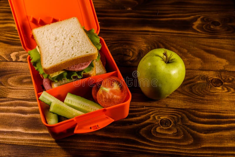 Lunch Box with Sandwich, Cucumbers, Green Apple and Tomatoes on Wooden Table Stock Photo Image