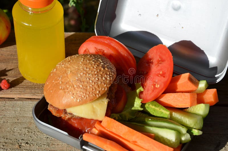 Lunch boxes with food ready to go for work or school, meal preparation or dieting concept. Hamburgers with lettuce. Bread, cuisine.