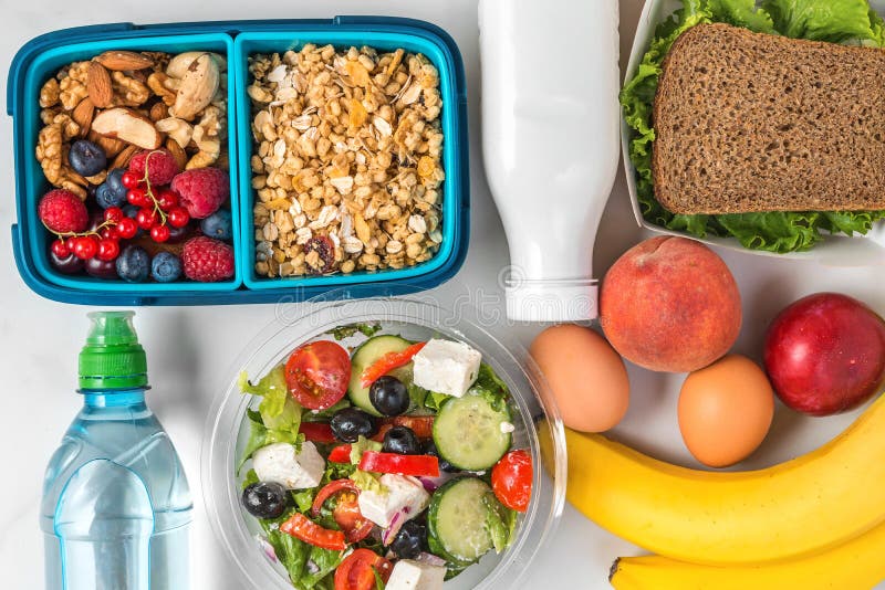 Lunch boxes with healthy food to take away for whole day. breakfast granola with yogurt, greek salad, sandwich royalty free stock image Lunch boxes with healthy food to take away for whole day. breakfast granola with yogurt, greek salad, sandwich royalty free stock image