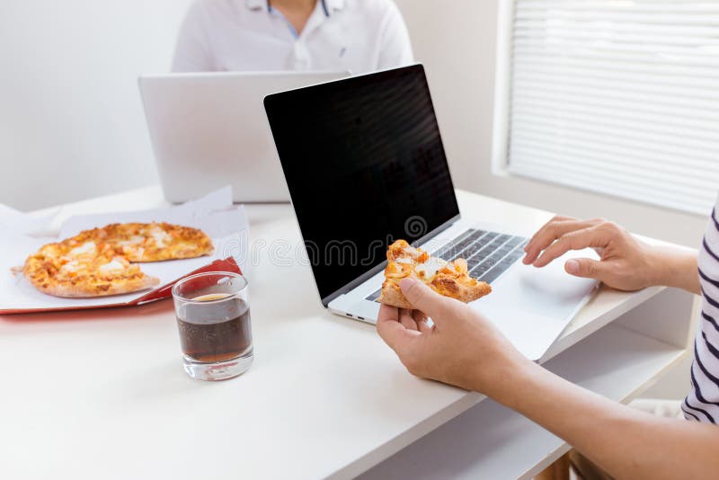 Lunch and people concept. Happy business team eating pizza in of stock images Lunch and people concept. Happy business team eating pizza in of stock images