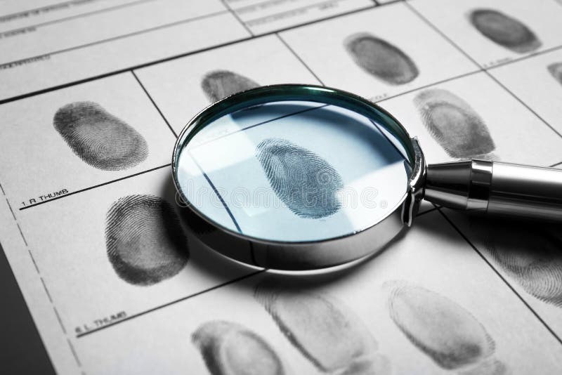 Magnifying glass and criminal fingerprint card, closeup. Magnifying glass and criminal fingerprint card, closeup