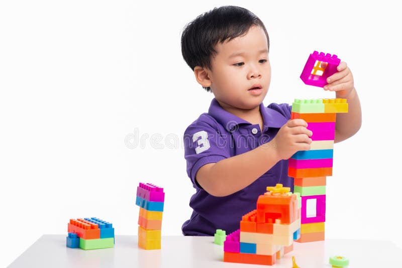 Kid boy playing with blocks from toy constructor isolated. Kid boy playing with blocks from toy constructor isolated.