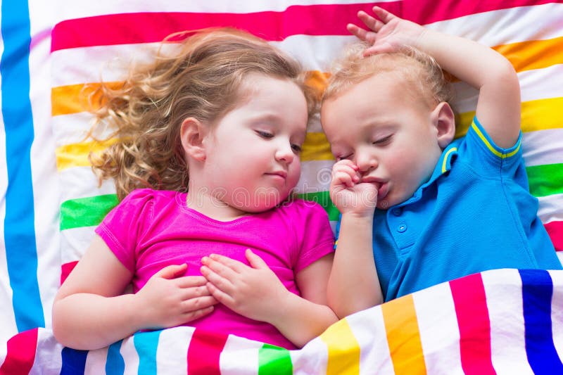Lustige Kinder, die unter bunter Decke schlafen stockfoto Lustige Kinder, die unter bunter Decke schlafen stockfoto