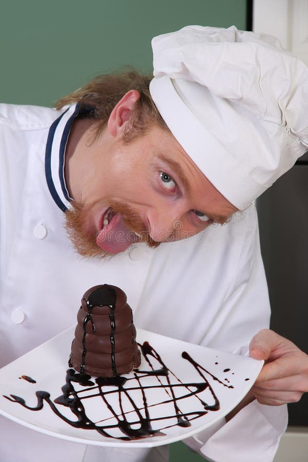 Funny young chef eating a piece of cake with chocolate sauce. Funny young chef eating a piece of cake with chocolate sauce