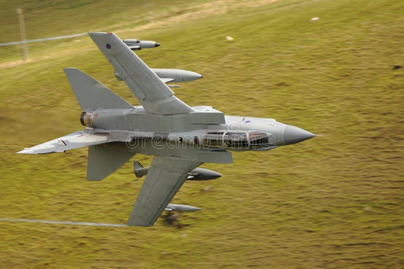 Low level Tornado GR4 jet fighter flying over green fields in countryside, Wales. Low level Tornado GR4 jet fighter flying over green fields in countryside, Wales.