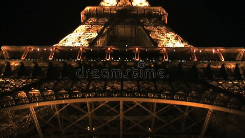 Lutande ner från Eiffeltorn på natten