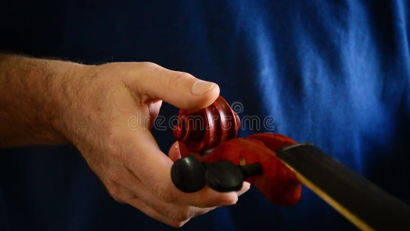 Luthier placing the pins in a violin or viola in the workplace