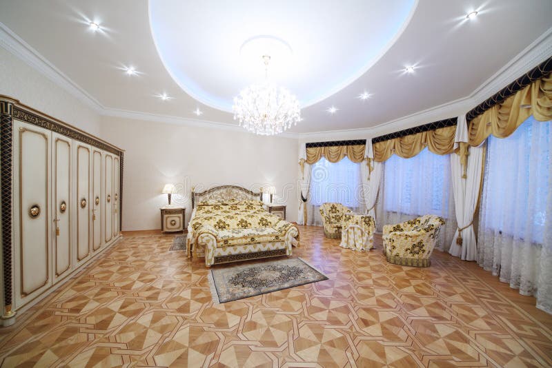 Luxurious Bedroom with Beautiful Double Bed, with Armchairs Stock Photo