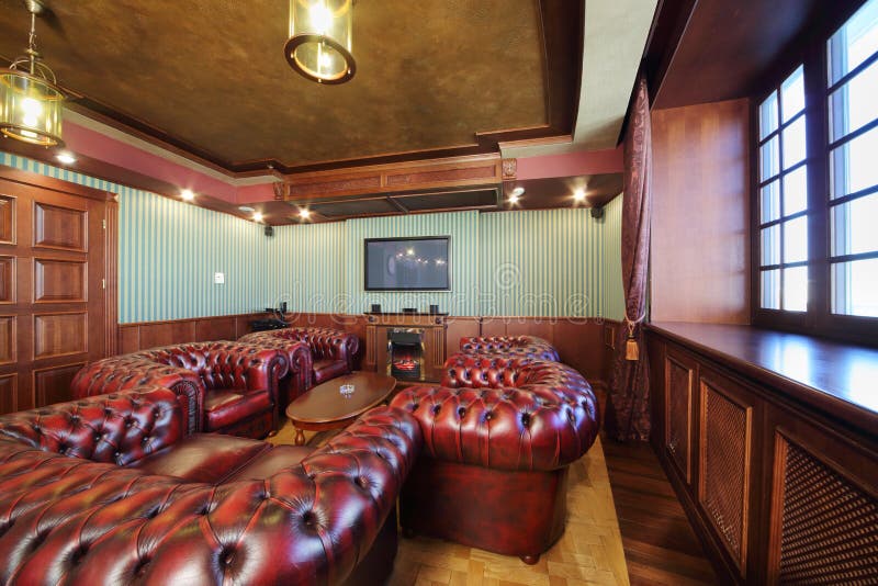 Luxurious english cigar room with leather armchairs
