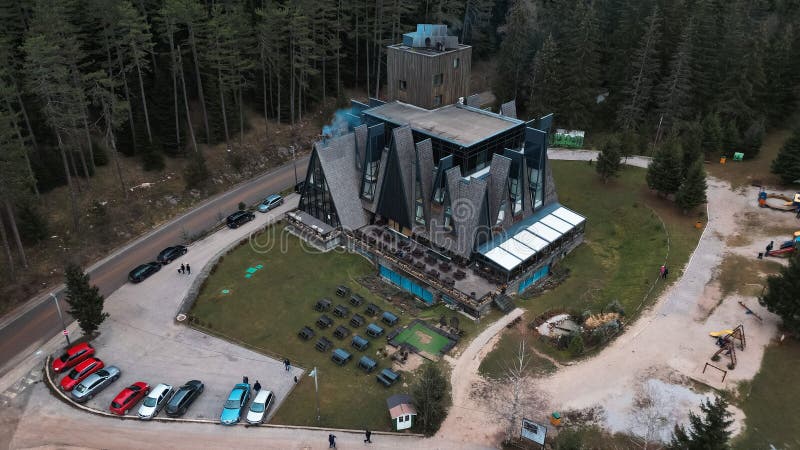 Luxurious hotel nestled among tall pine trees in the daylight in Trebevic, Bosnia and Herzegovina