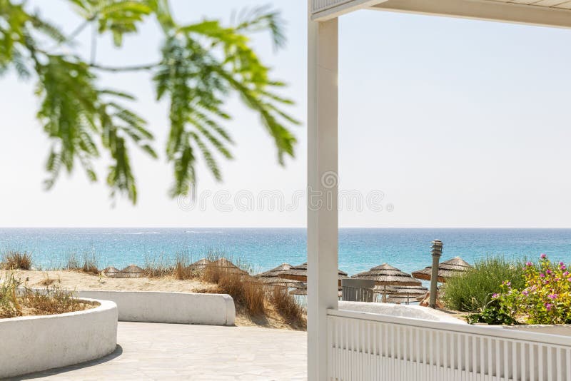Luxurious white terrace in a tropical resort with sea views. Bright blue sky on a sunny day. Background. Space for text