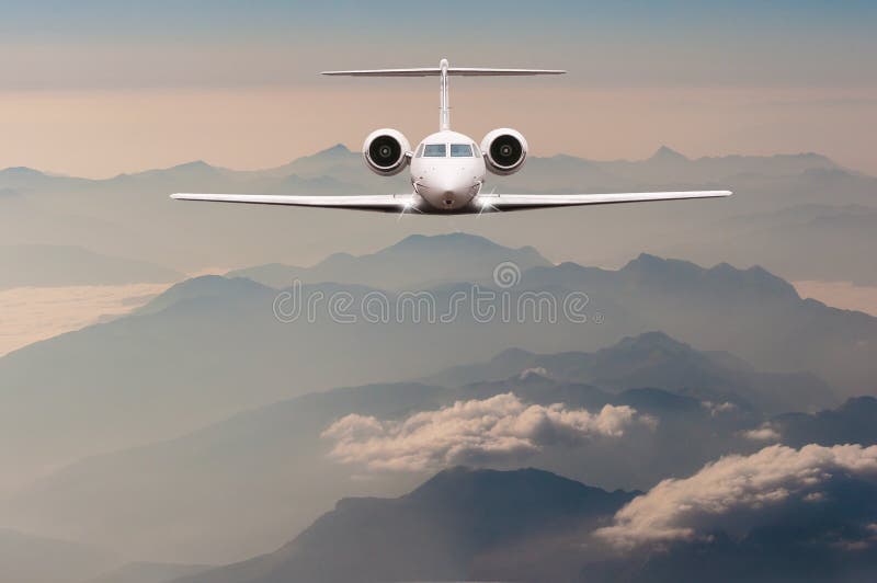 Luxury Airplane fly over clouds and Alps mountain on sunset. Front view of a big passenger or cargo aircraft, business royalty free stock photos Luxury Airplane fly over clouds and Alps mountain on sunset. Front view of a big passenger or cargo aircraft, business royalty free stock photos