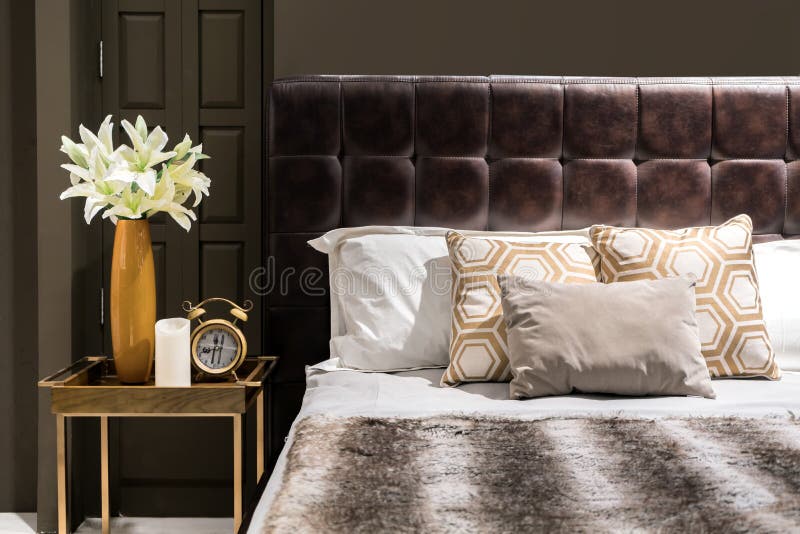 Luxury bedroom with brown color tone and flower vase and clock o