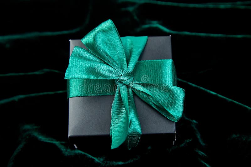 Luxury black gift boxes with green ribbon on shine velvet background. Christmas, birthday party presents. Father Day. Flat lay.