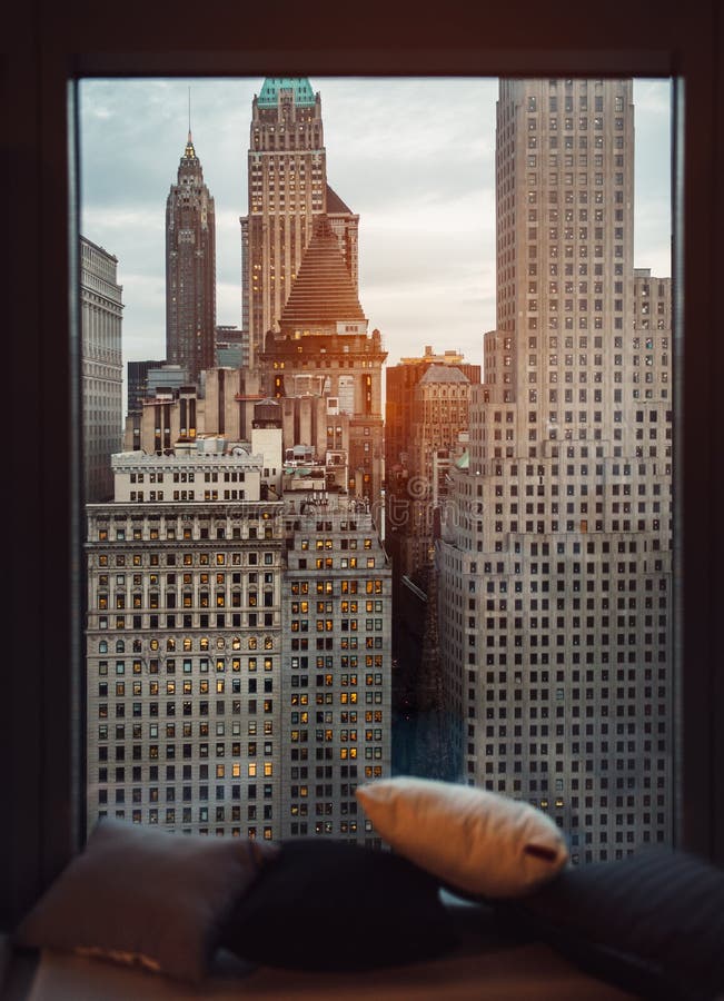 Luxury cozy window sill with view to New York City skyscrapers at sunset time. Coffee drinking place. stock images Luxury cozy window sill with view to New York City skyscrapers at sunset time. Coffee drinking place. stock images