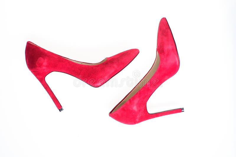 Luxury footwear concept. Footwear with thin high heels, stiletto shoes, top view. Shoes made out of red suede on white stock images Luxury footwear concept. Footwear with thin high heels, stiletto shoes, top view. Shoes made out of red suede on white stock images