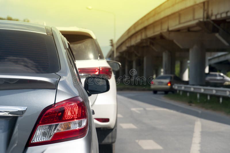 Gray car on the road with bridge. Luxury of gray car open brake light on the asphalt road. with other car u-turn under side level bridge royalty free stock photo Gray car on the road with bridge. Luxury of gray car open brake light on the asphalt road. with other car u-turn under side level bridge royalty free stock photo