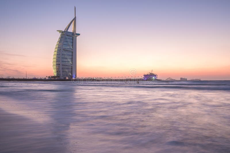 Luxury hotel Burj Al Arab and public beach at sunset. Dubai, UAE - 29/NOV/2016. Luxury hotel Burj Al Arab and public beach at sunset on a windy day, photographed stock photo Luxury hotel Burj Al Arab and public beach at sunset. Dubai, UAE - 29/NOV/2016. Luxury hotel Burj Al Arab and public beach at sunset on a windy day, photographed stock photo