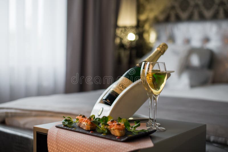 Luxury Hotel Room with a Table with Snacks and Champagne Glasses Close